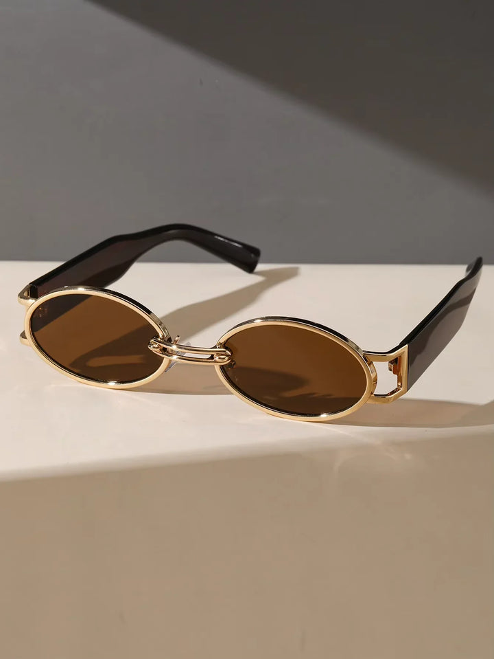 Close-up of Unisex Oval Luxe UV400 Sunglasses, golden frames, dark lenses, premium eyewear accessory