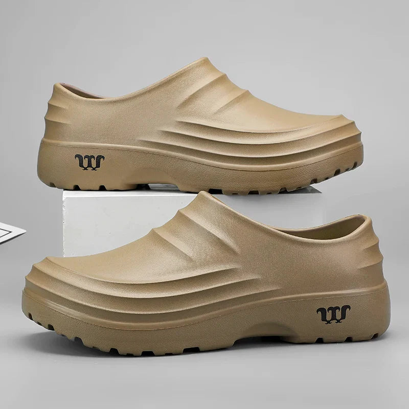 Pair of black unisex professional work clogs, designed for comfort and support during long shifts.
