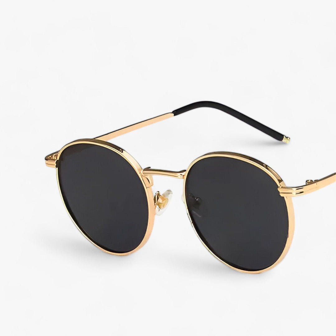 Unisex round sunglasses with sleek black metal frame for stylish UV protection. Perfect fashion eyewear.