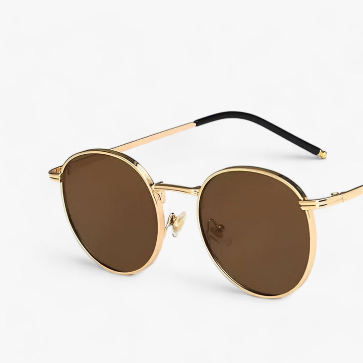 Classic black round sunglasses with a durable metal frame. Unisex design offers UV protection & sleek style.