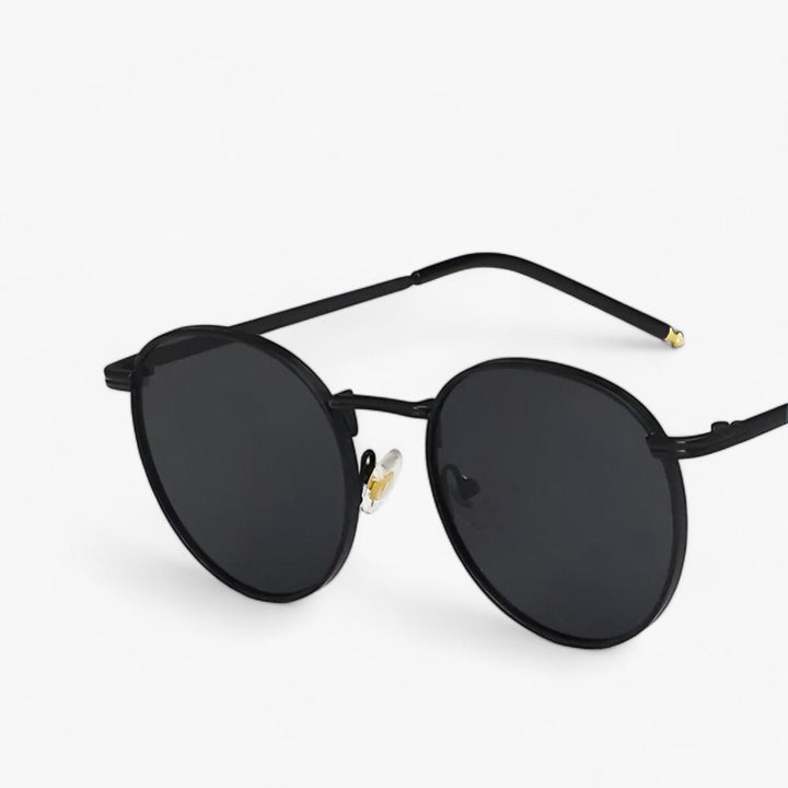 Unisex round metal frame sunglasses providing essential UV protection. Ideal travel accessory for outdoor adventures.