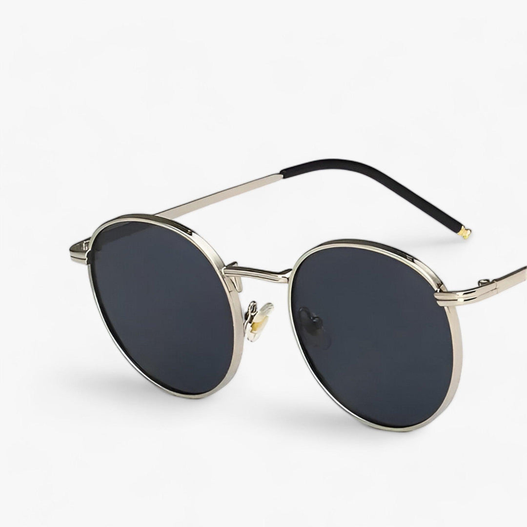 Designer unisex round sunglasses with a classic metal frame. Fashionable eyewear offering superior UV protection.