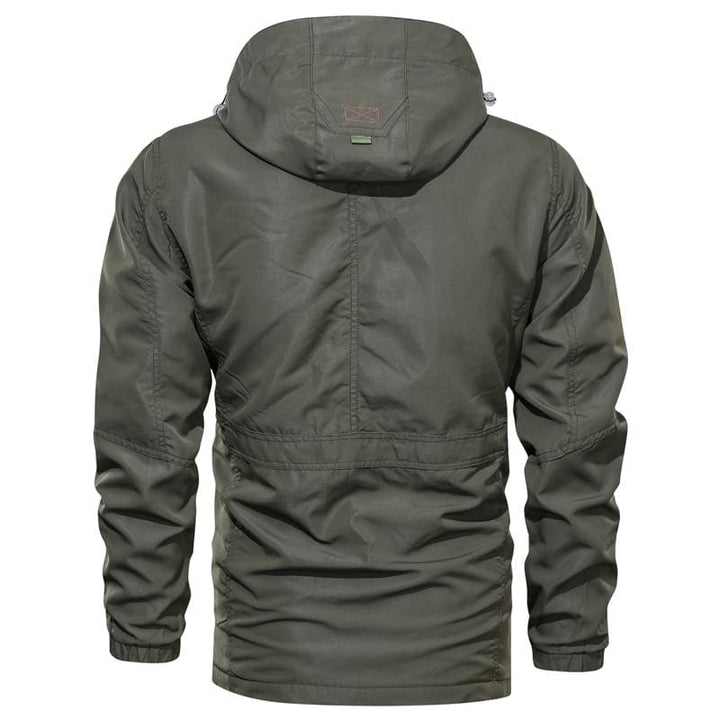 Full-length shot of a person hiking in a green Unisex Ultralight Outdoor Parka, suitable for all genders