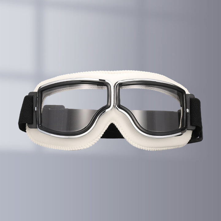 Rider wearing vintage motorcycle goggles, ensuring clear vision & eye safety. Essential retro riding gear.