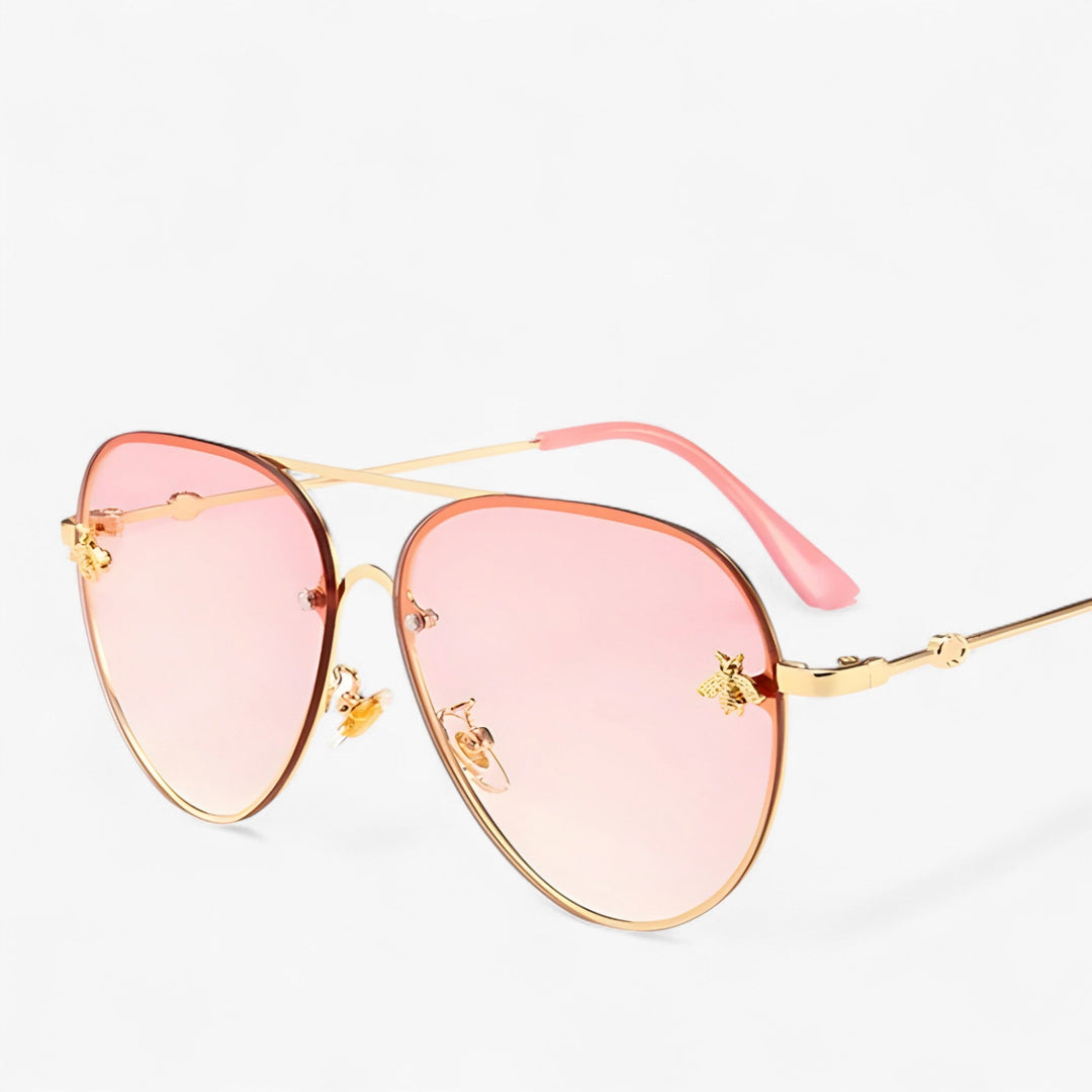 Elegant bee detail on stylish vintage pilot sunglasses, a unique luxury eyewear accessory for fashion lovers.