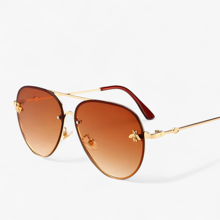 Close-up: Elegant bee detail on the temple of vintage pilot sunglasses, showcasing premium luxury eyewear design.