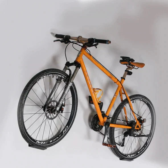 Space-saving vertical bike storage rack, securely hangs bikes in garage or home.