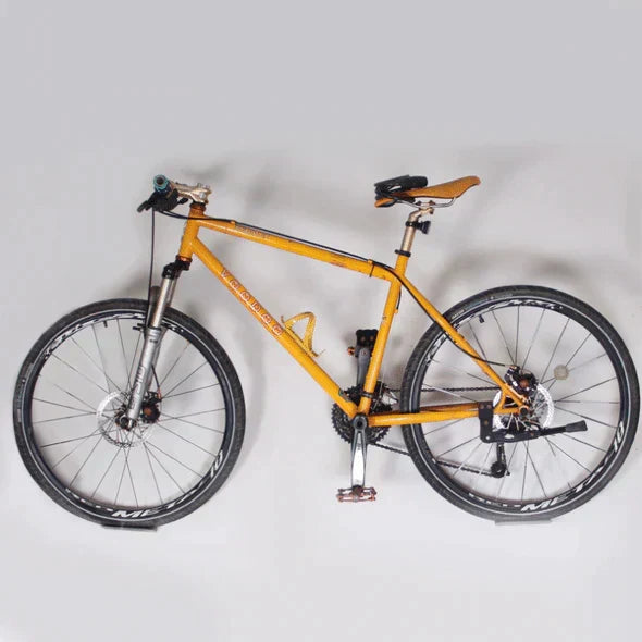 Compact wall bike rack, ideal for small spaces. Heavy-duty carbon steel bicycle holder.