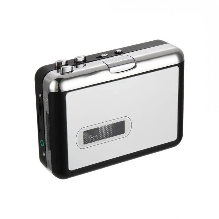Hand holding a USB cassette converter, connecting it to a laptop to digitize old music tapes to MP3.