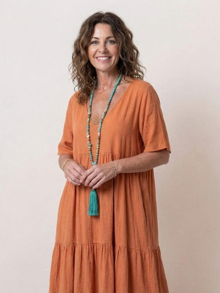 Lightweight women's V-neck maxi dress, tiered boho style, perfect for warm weather.