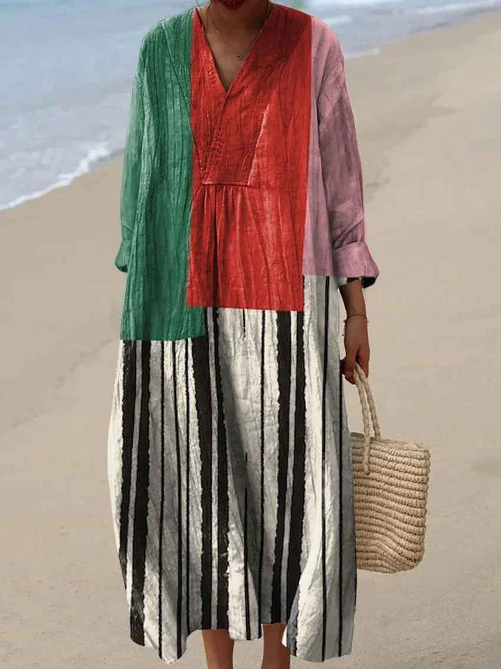 Detailed vibrant patchwork long-sleeve maxi dress. Bohemian V-neck for women's elegant casual summer fashion.
