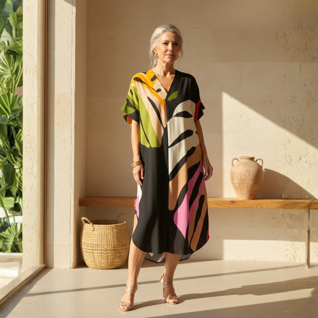 Vibrant women's abstract print V-neck shift dress, perfect for casual summer fashion. Relaxed fit short sleeve style.