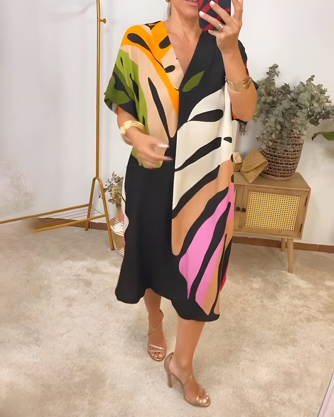 Casual women's short sleeve V-neck shift dress with a modern abstract print, ideal for everyday summer wear.