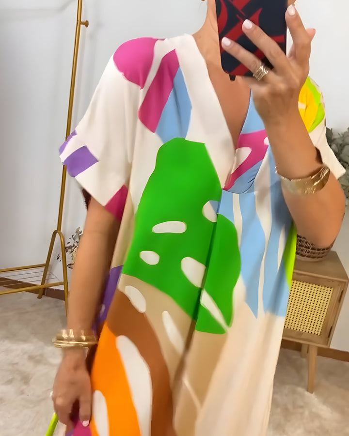 Relaxed fit women's V-neck shift dress with a vibrant abstract print and comfortable short sleeves for summer.