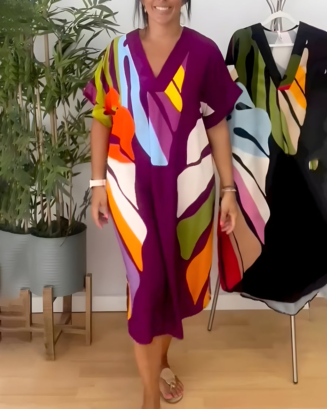 Trendy women's abstract print V-neck shift dress. Short sleeve, relaxed fit, and vibrant, perfect for summer days.