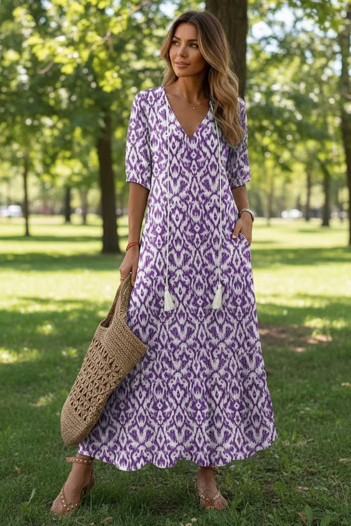 Woman in a vibrant flowy summer maxi dress, ideal for beach walks, vacation, or elegant casual outings.