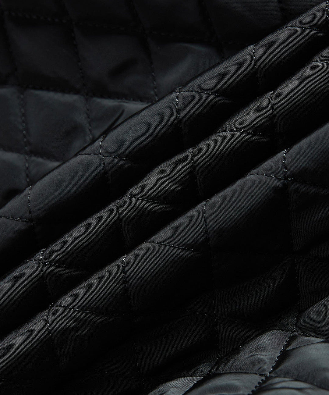Man zipping up his black insulated sherpa-lined winter jacket, preparing for cold outdoor activities