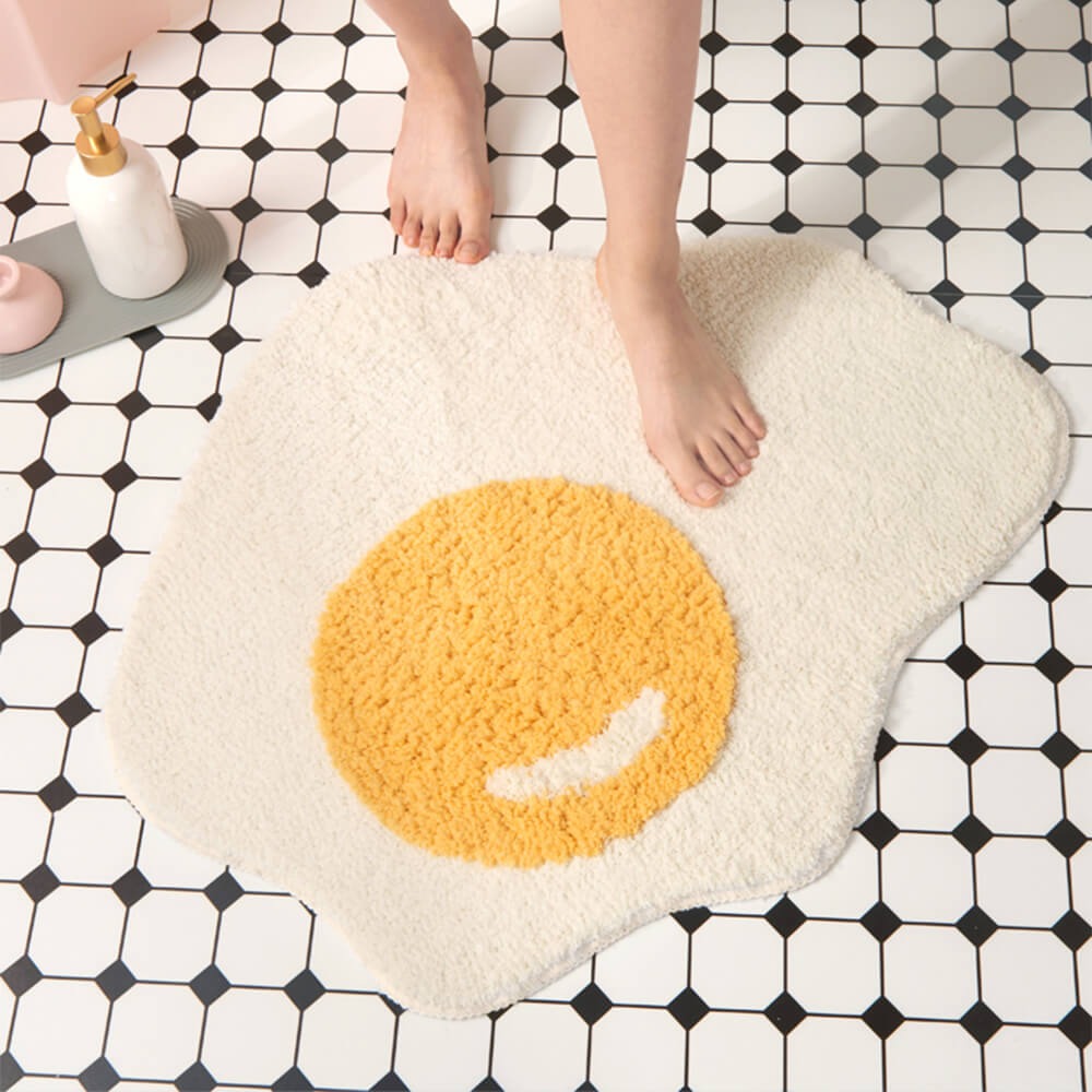 Comfortable fried egg shaggy bath mat. Super soft, absorbent, non-slip, and machine washable. Fun kitchen decor.
