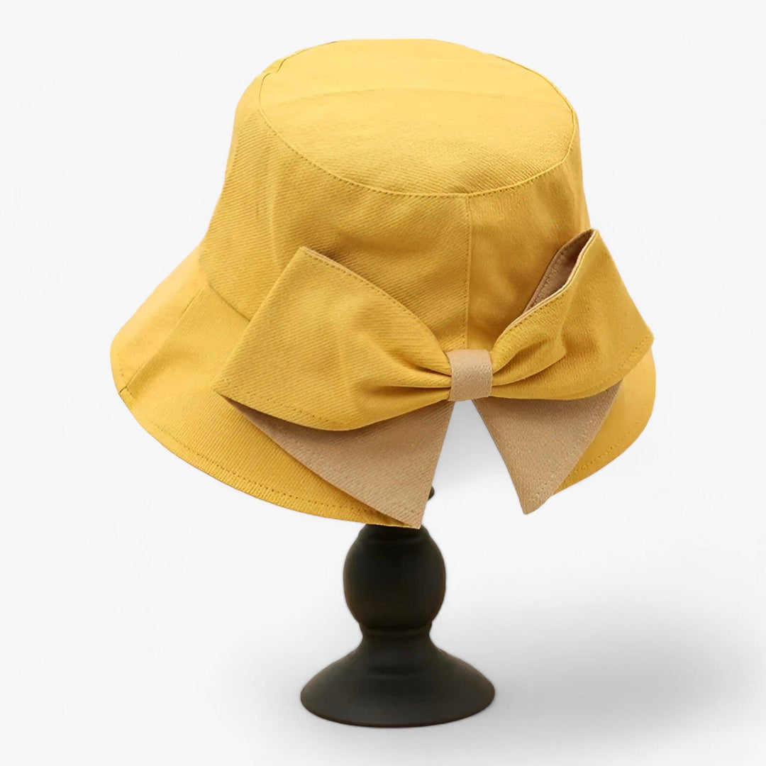 Casual white cotton bucket hat for women, perfect for beachwear & summer travel.