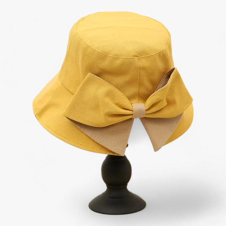 Casual white cotton bucket hat for women, perfect for beachwear & summer travel.