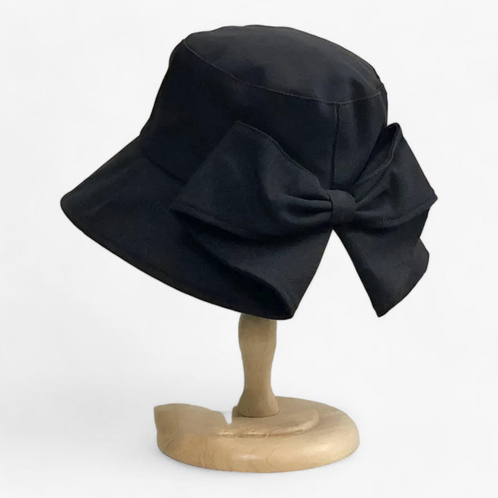 Casual white cotton women's bucket hat, breathable, for beach, travel & sun protection.