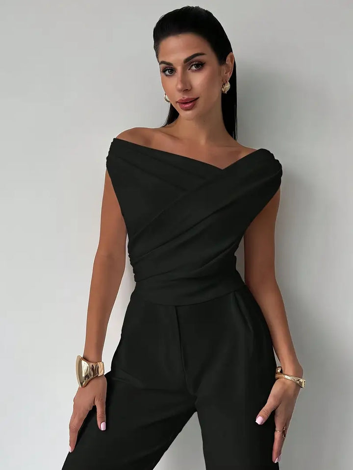 Versatile white women's top, elegant and chic with a distinctive draped shoulder.