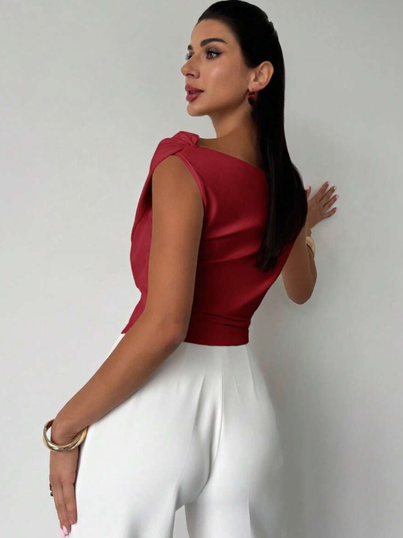 White chic women's blouse with an elegant draped shoulder, ideal for versatile styling.