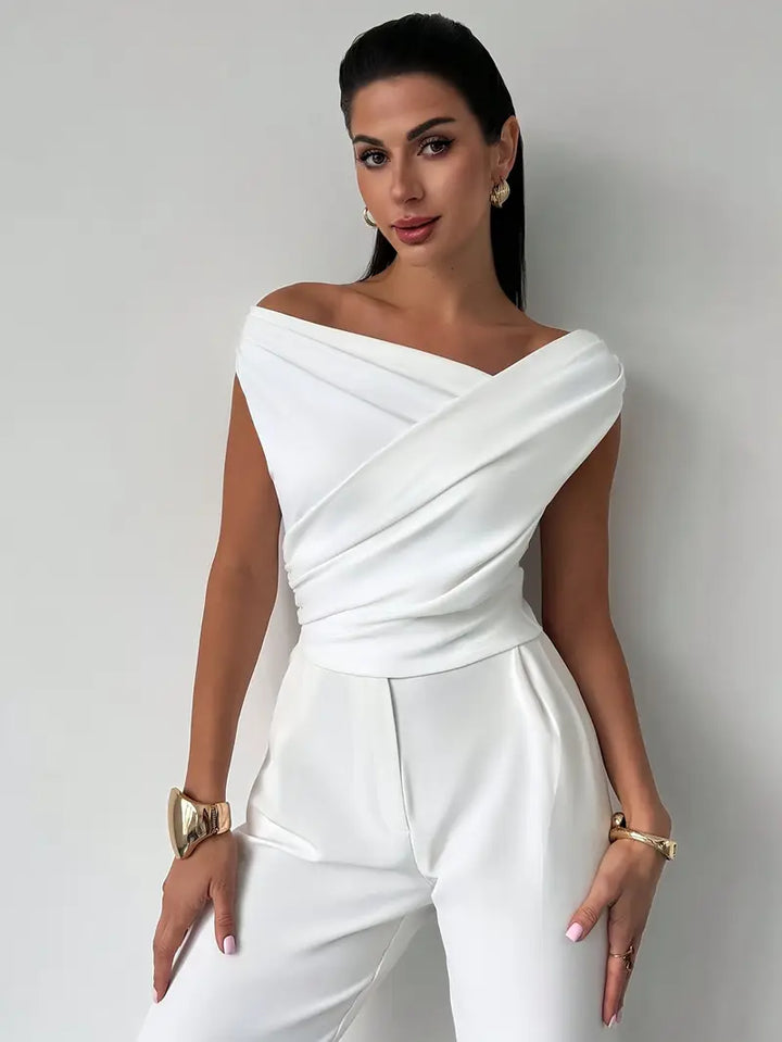 Sophisticated women's white top with elegant draped shoulder for various occasions.
