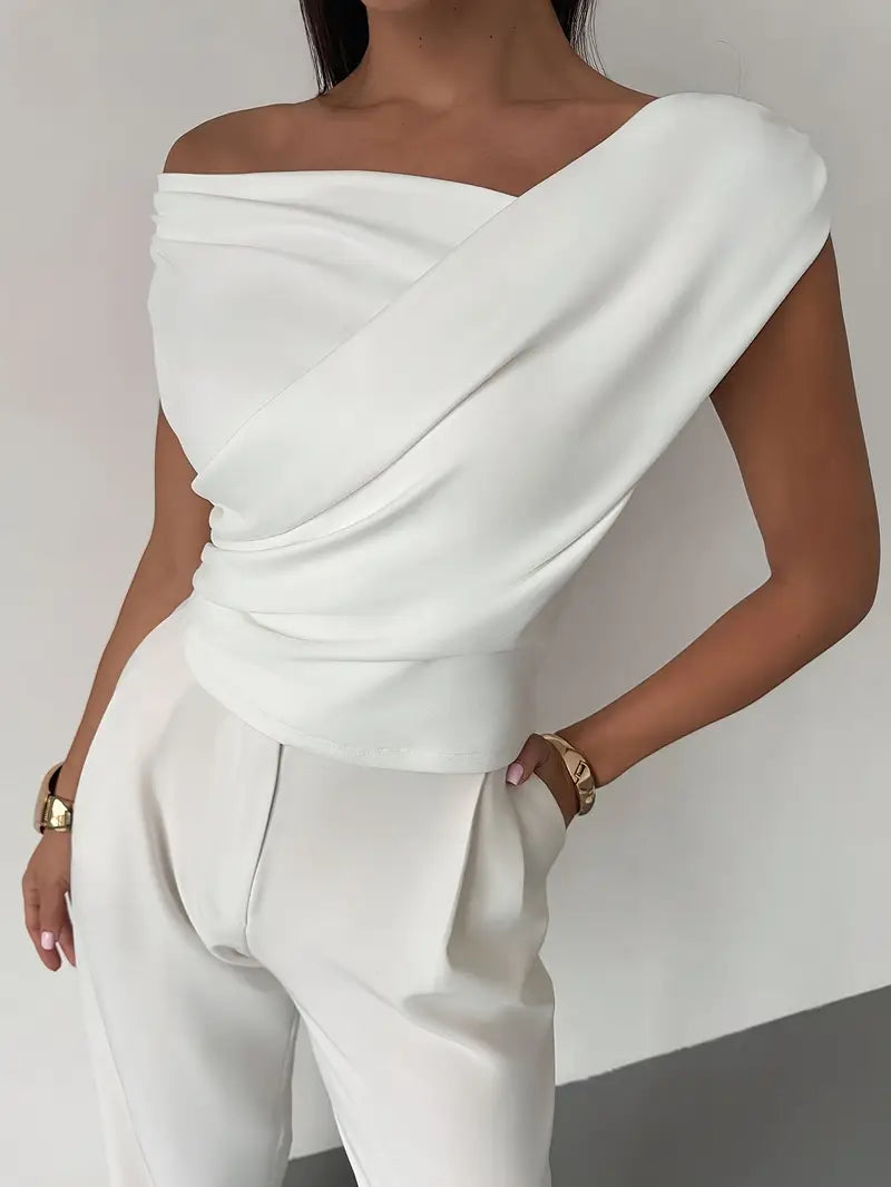 Modern black draped shoulder blouse, a versatile top for office or evening wear.