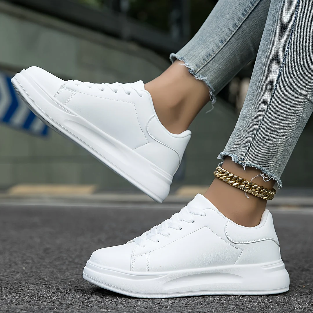 White women's platform lace-up sneakers, stylish and comfortable for casual everyday wear.