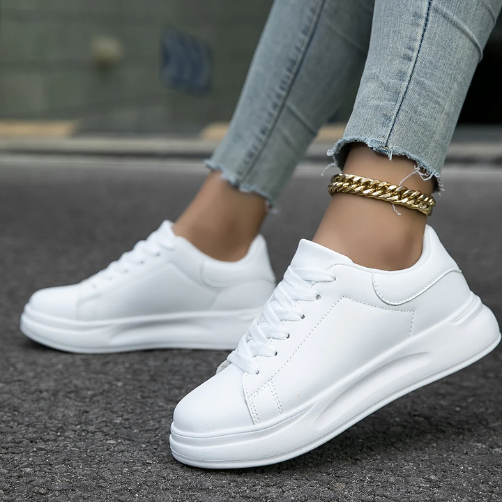 Fashionable women's platform sneakers with lace-up design, perfect for elevating casual outfits.