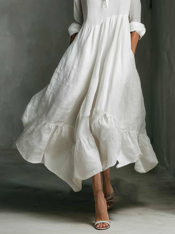 Elegant white maxi dress for women. Long sleeve, tiered design, & relaxed fit make it a versatile casual summer outfit.