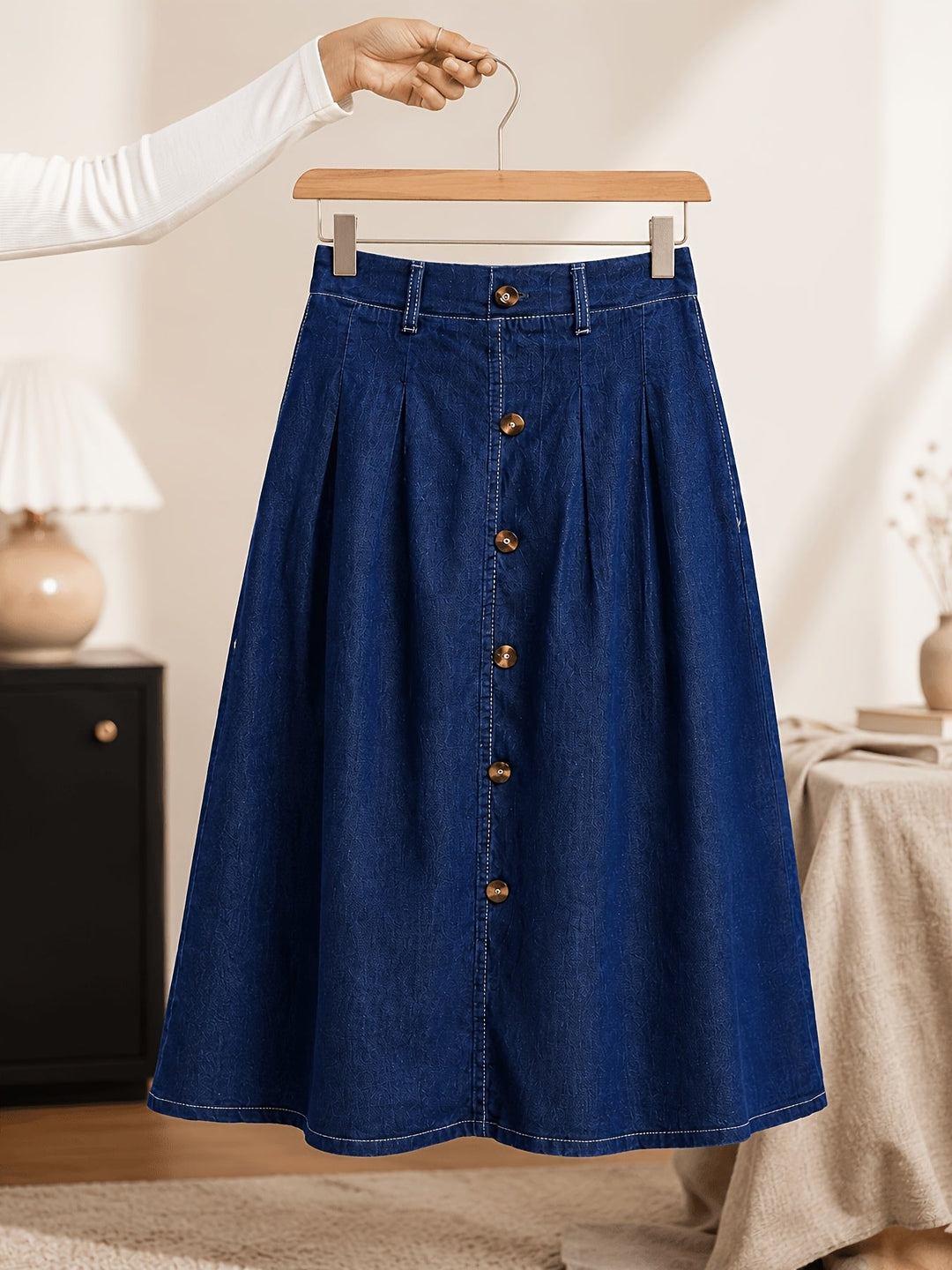 Versatile medium blue A-line midi skirt for women, featuring a chic button front and flattering silhouette.
