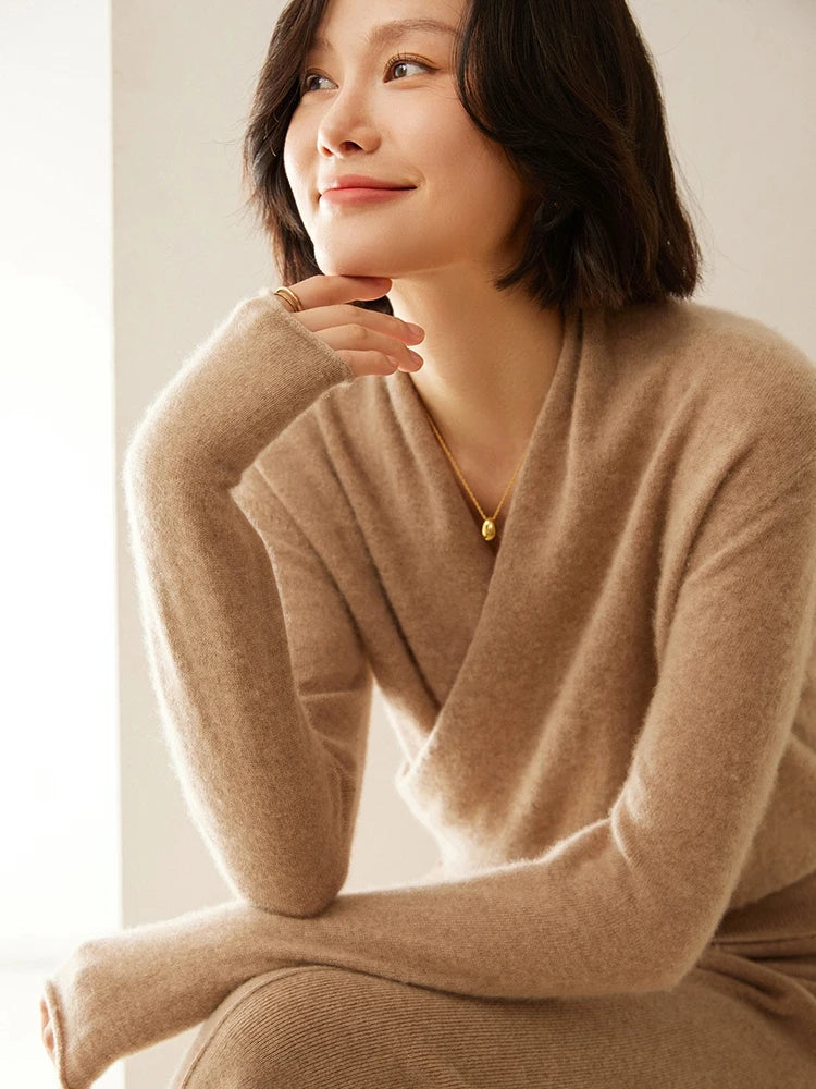 Woman wearing a luxurious camel cashmere crossover sweater, cozy knitwear