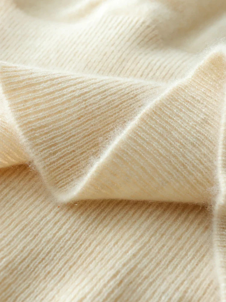Detail of the soft knit on a beige cashmere crossover sweater
