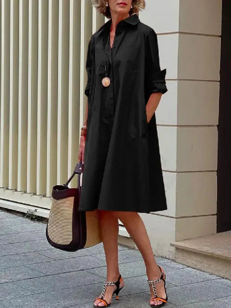 Women's A-line midi shirt dress with button-front, long sleeves. Effortless style for casual or smart casual wear.