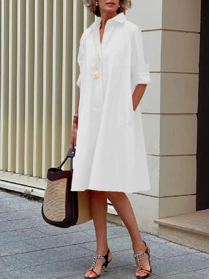 Chic women's long-sleeve A-line midi shirt dress. Button-front design, ideal for a smart casual and comfortable look.