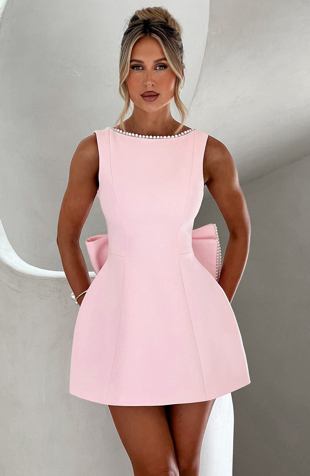 Women's A-line mini homecoming dress with elegant pearl trim.