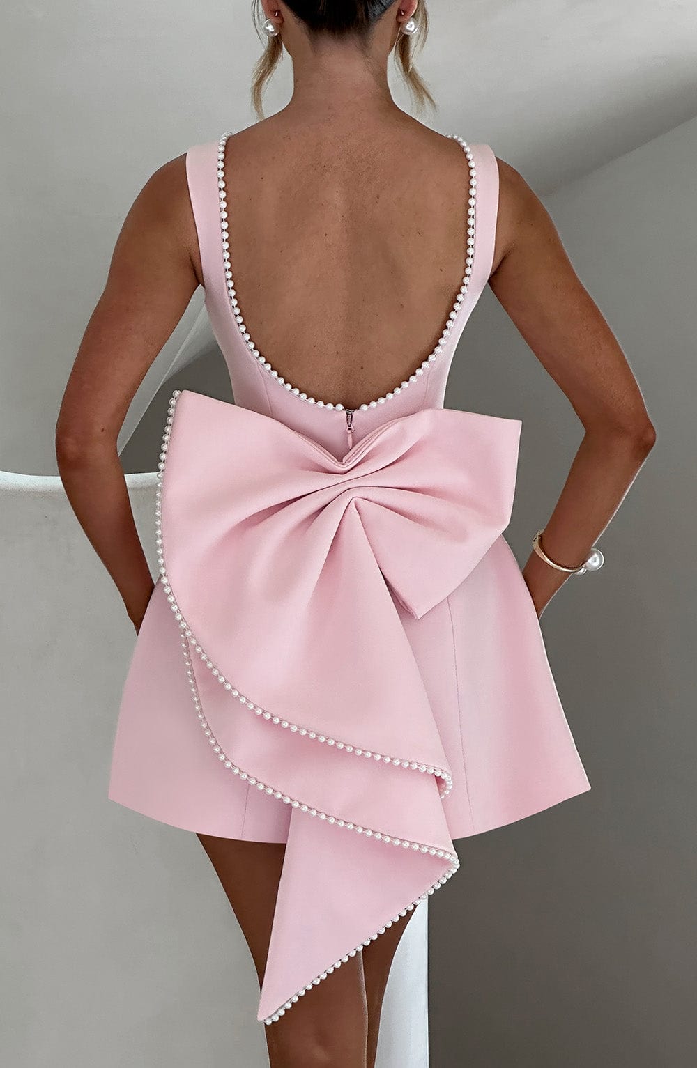 Chic women's short A-line party dress with sophisticated pearl detailing for special occasions.