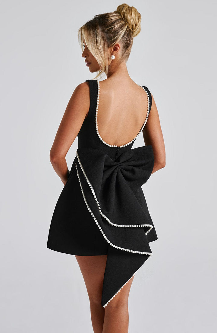 Stylish women's elegant A-line cocktail dress, short and adorned with beautiful pearl trim.