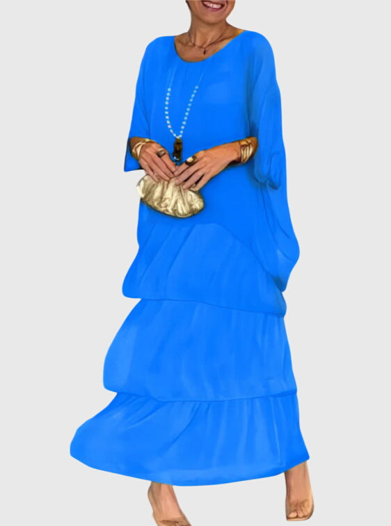 Women's tiered maxi dress in an abstract print, designed for comfort and elegance on warm days.