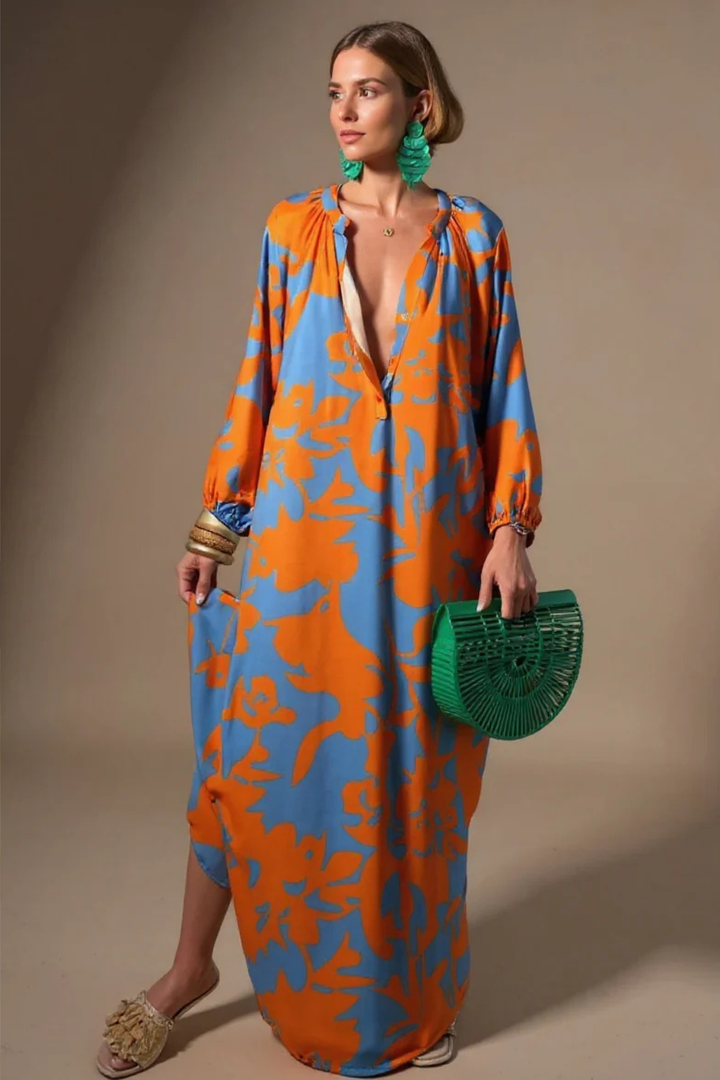 Stylish women's V-neck kaftan maxi dress with vibrant abstract print. Ideal for resort wear, beach, or casual summer style.