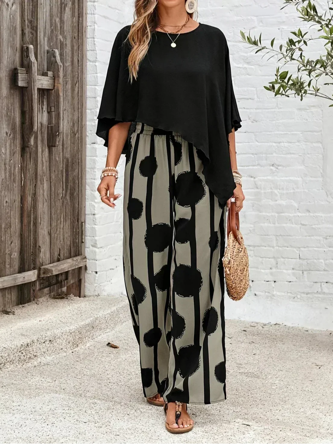Abstract print two-piece set featuring a flowy batwing top & fashionable wide leg trousers for women.