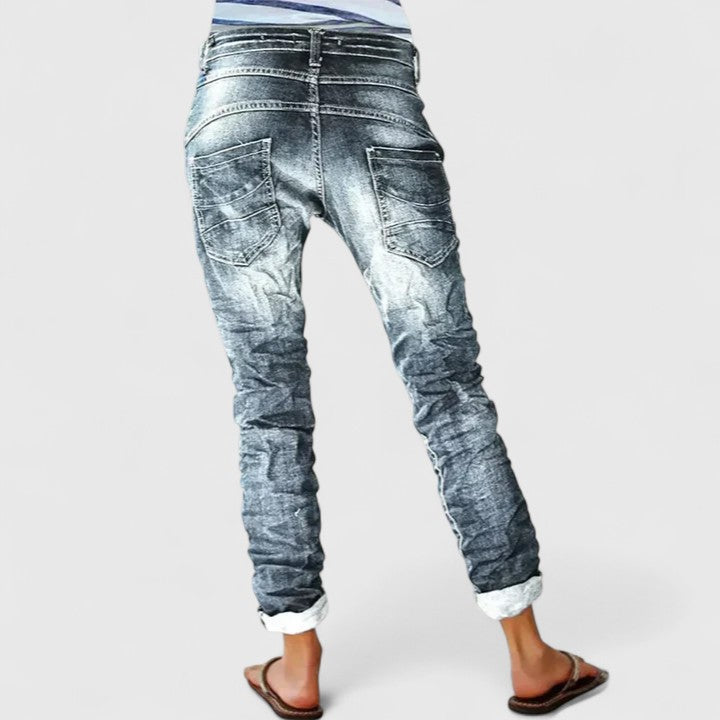 Trendy distressed acid wash skinny jeans for women, featuring unique contrast stitch and button fly.