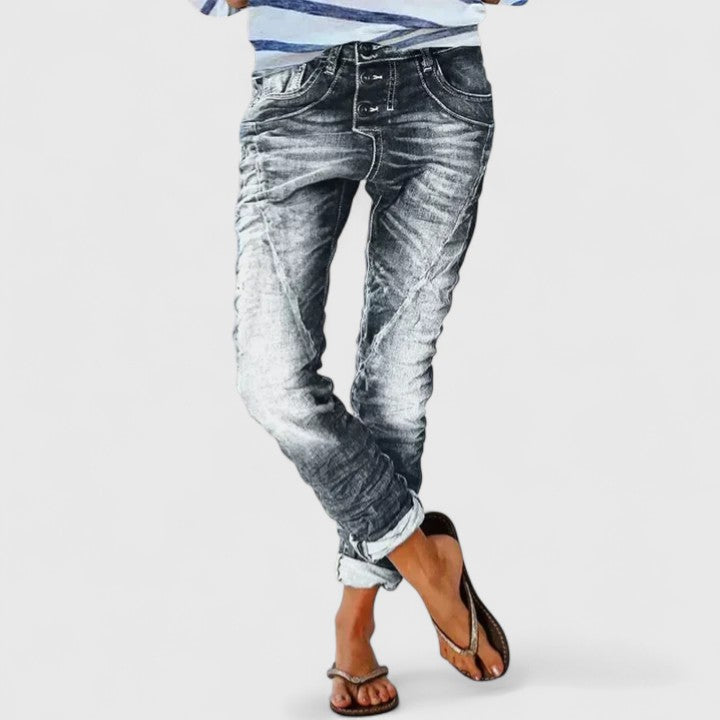 Vintage style women's acid wash skinny jeans, distressed, with distinct contrast stitch and button fly.