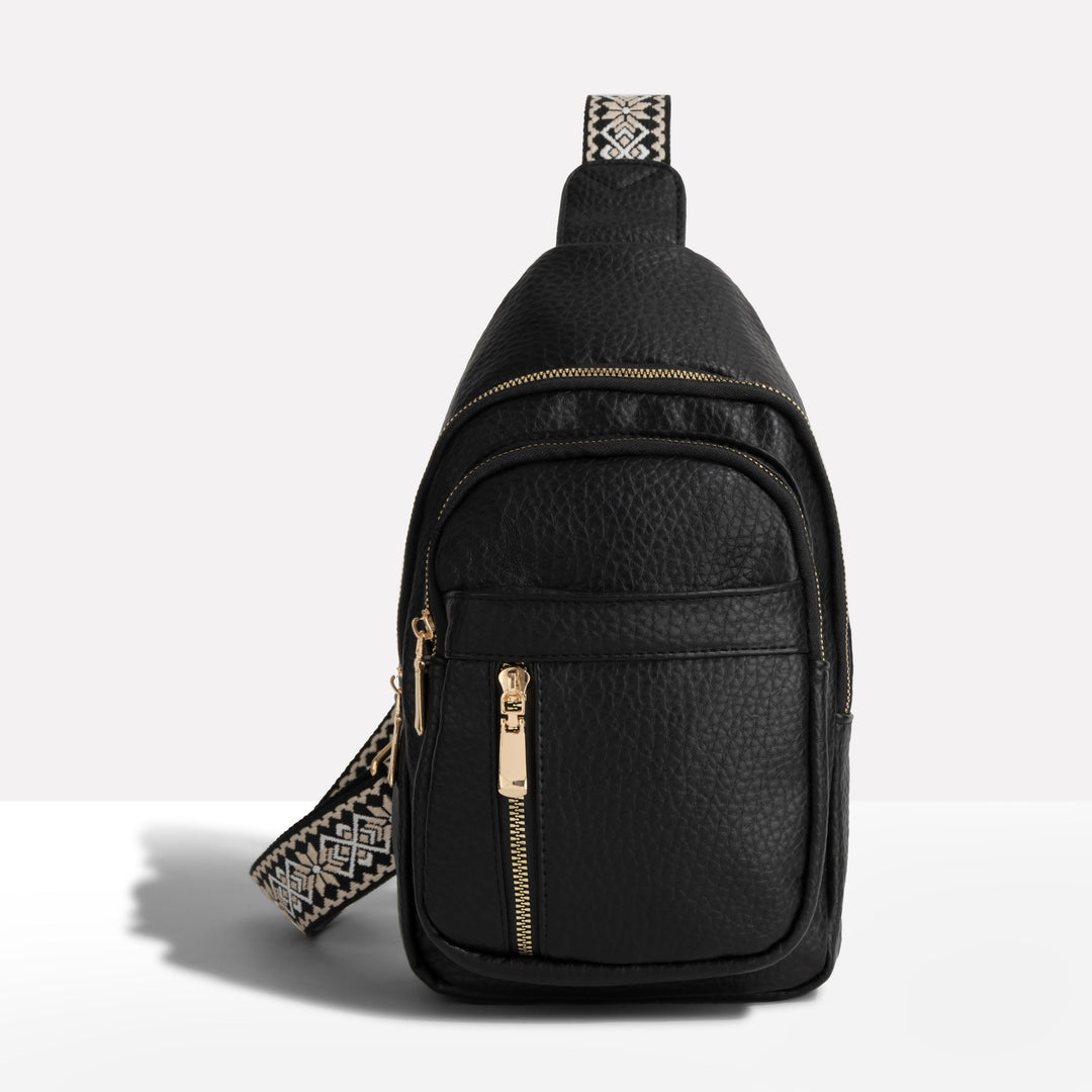 Women's anti-theft sling bag with patterned strap. Secure crossbody travel purse for everyday carry.