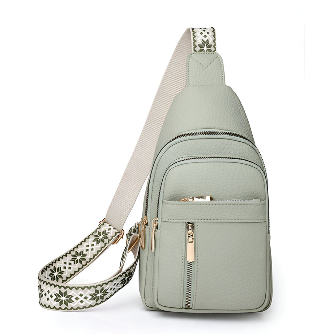 Women's anti-theft travel sling bag with secure zippers & a fashionable patterned adjustable strap.