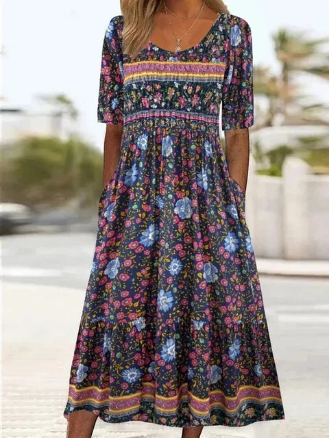 Artistic Bohemian Women's Midi Dress. Features vibrant floral print, round neck, short sleeves & handy pockets.