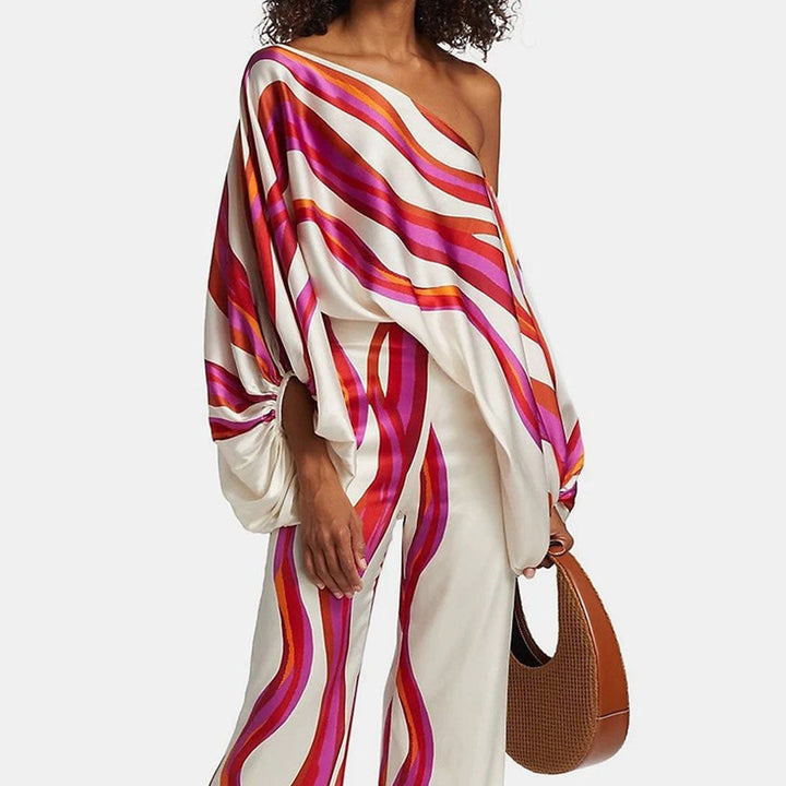 Women's artistic one-shoulder printed two-piece pants set with wide leg for chic resort wear.