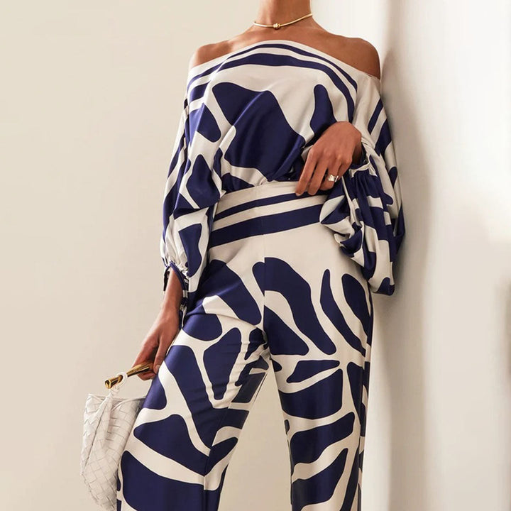 Model wearing a chic women's artistic printed one-shoulder two-piece pants set, ideal for resort.